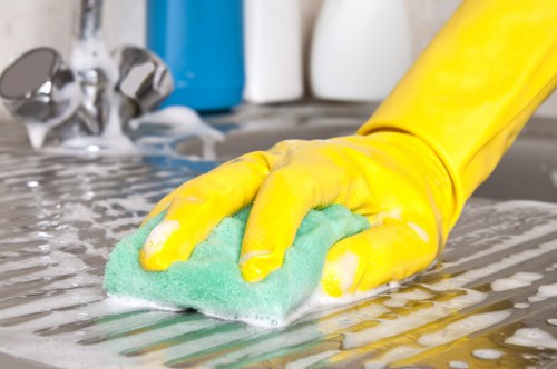 Local cleaner working on glass frontage in Westminster